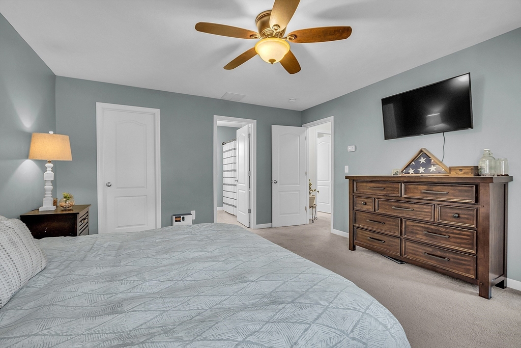 261 Bean Porridge Hill Road Westminster, MA 01473 - Photo 23 of 33 a bedroom with a bed and a flat tv screen on dresser