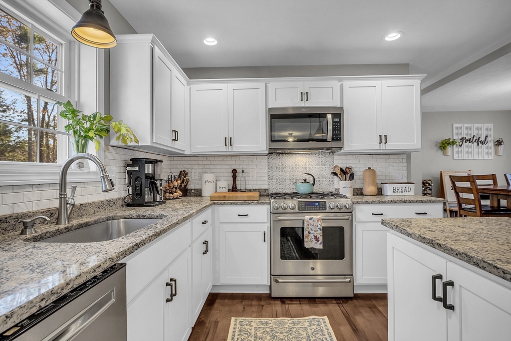 261 Bean Porridge Hill Road Westminster, MA 01473 - Photo 5 of 33 a kitchen with granite countertop a sink stove and cabinets