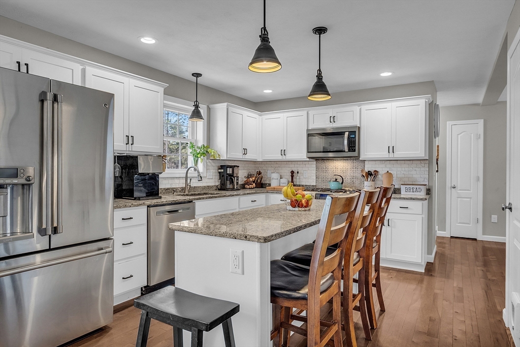 261 Bean Porridge Hill Road Westminster, MA 01473 - Photo 8 of 33 a kitchen with stainless steel appliances granite countertop a refrigerator a stove a sink a microwave and a refrigerator with wooden floor