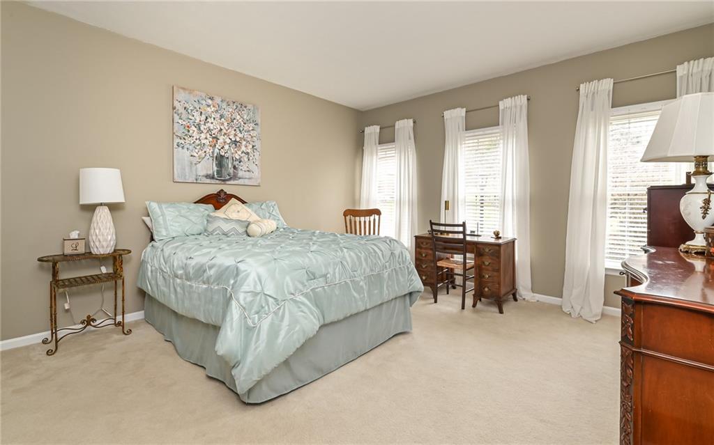 216 Sycamore Drive Seven Fields, PA 16046 - Photo 11 of 25 a bedroom with a bed and a table in it with window