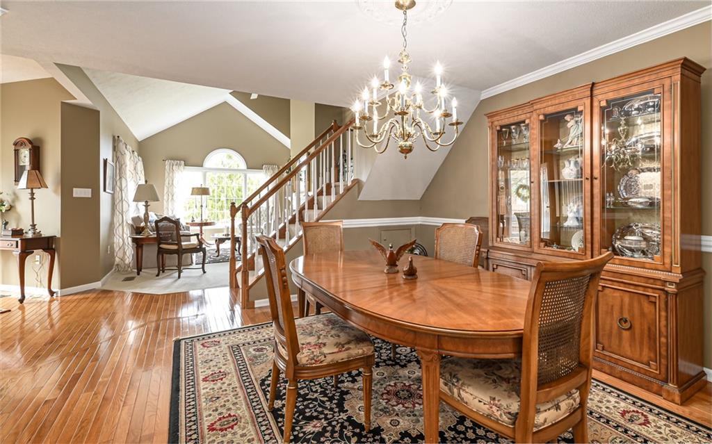 216 Sycamore Drive Seven Fields, PA 16046 - Photo 7 of 25 a view of a dining room with furniture a chandelier and wooden floor