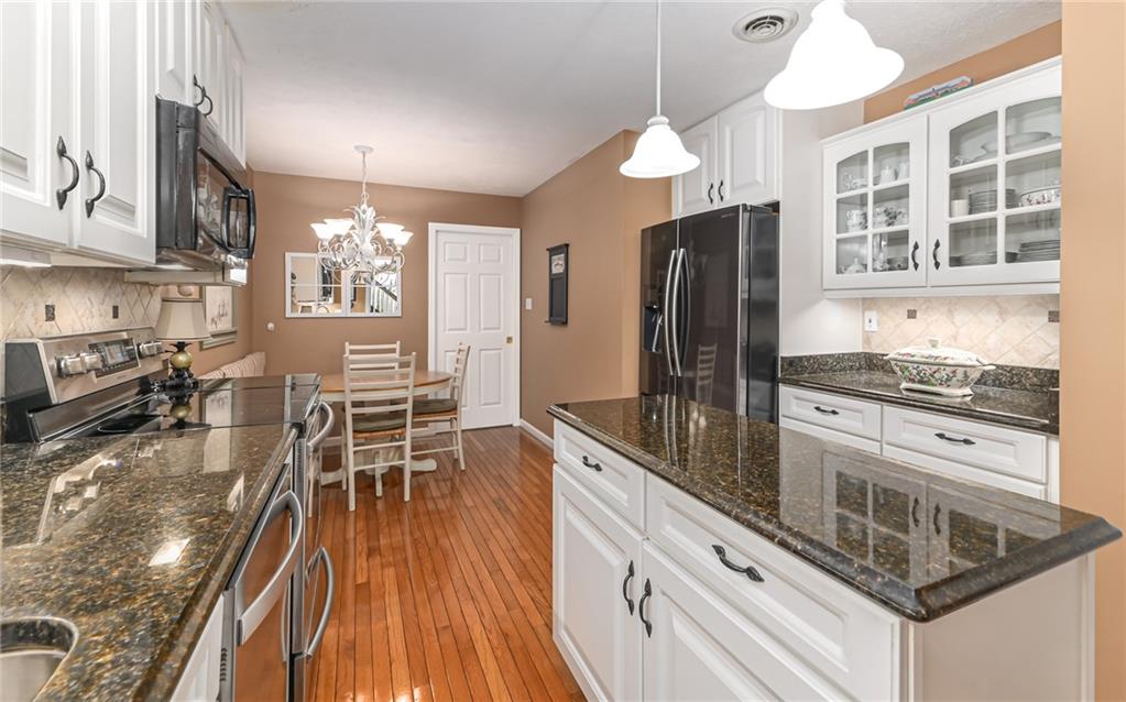 216 Sycamore Drive Seven Fields, PA 16046 - Photo 9 of 25 a kitchen with stainless steel appliances granite countertop a stove refrigerator and cabinets
