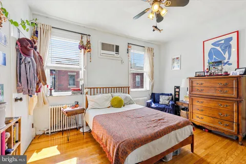 a bedroom with a bed dresser and a window