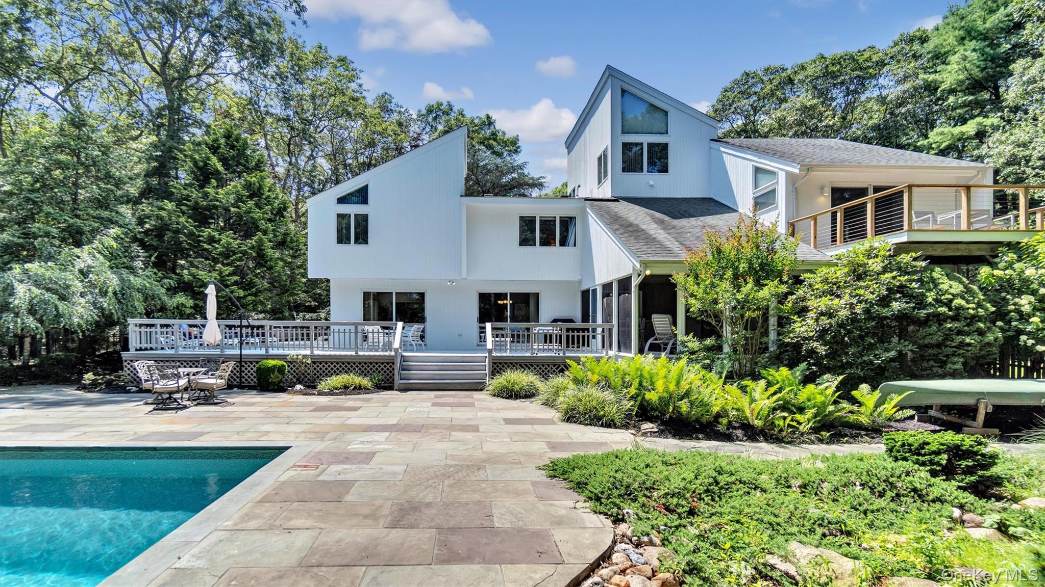 80 Inlet View Path East East Moriches, NY 11940 - Photo 1 of 1 a front view of a house with a garden and sitting area
