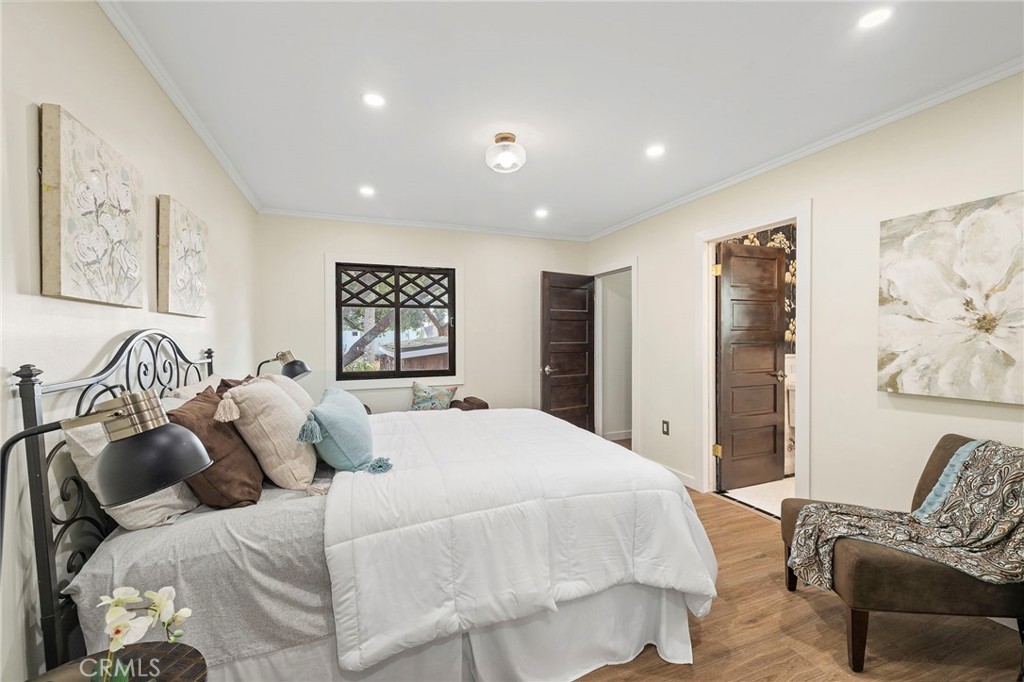 12428 Pasadena Street Whittier, CA 90601 - Photo 16 of 25 a bedroom with a large bed and a couch