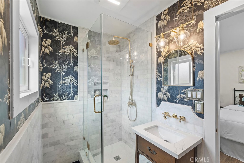 12428 Pasadena Street Whittier, CA 90601 - Photo 19 of 25 a bathroom with a sink vanity granite shower and a mirror