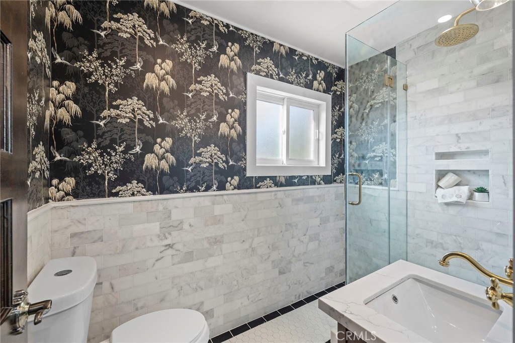 12428 Pasadena Street Whittier, CA 90601 - Photo 20 of 25 a bathroom with a sink mirror vanity and toilet