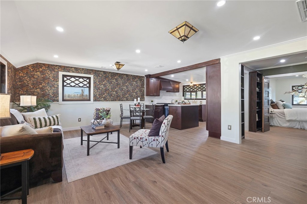 12428 Pasadena Street Whittier, CA 90601 - Photo 4 of 25 a living room with furniture and wooden floor