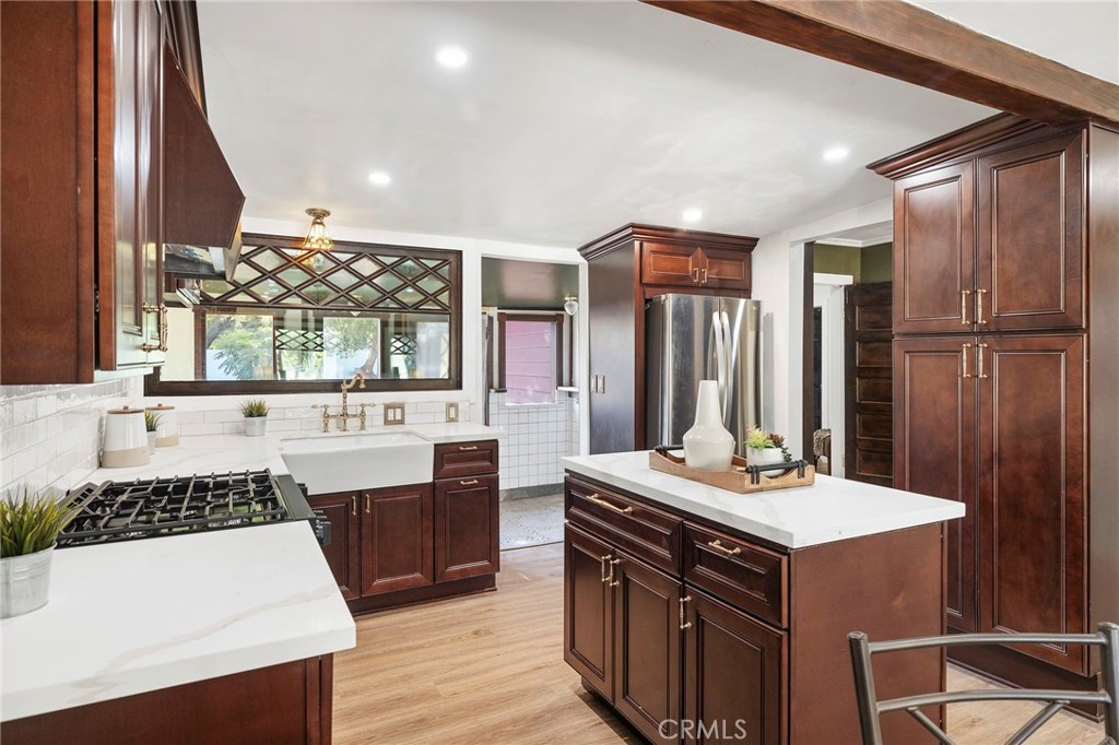 12428 Pasadena Street Whittier, CA 90601 - Photo 8 of 25 a kitchen with a sink stove and refrigerator