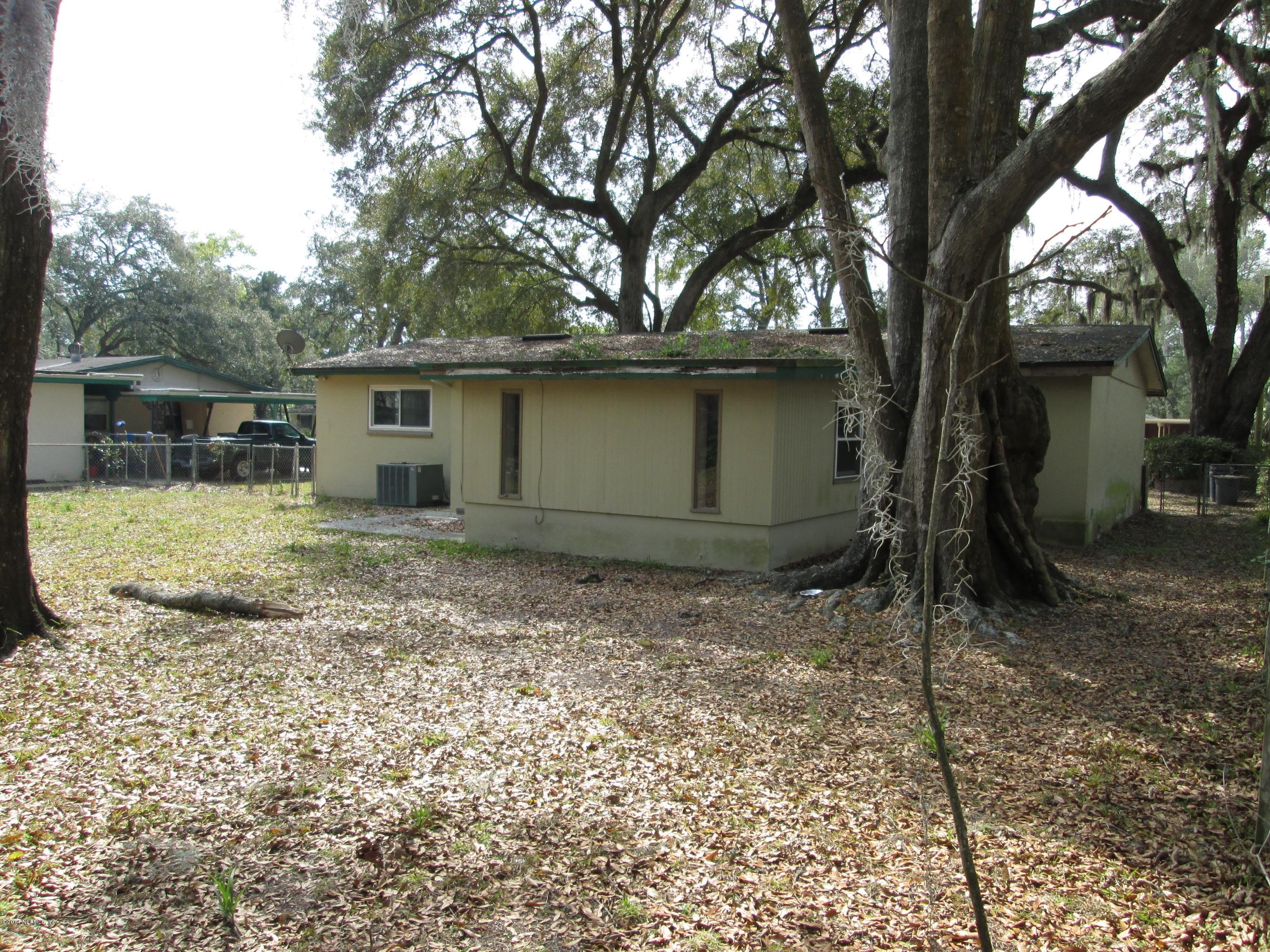 2235 Newberry Road Jacksonville, FL 32218 - Photo 3 of 12 a house with trees in the background