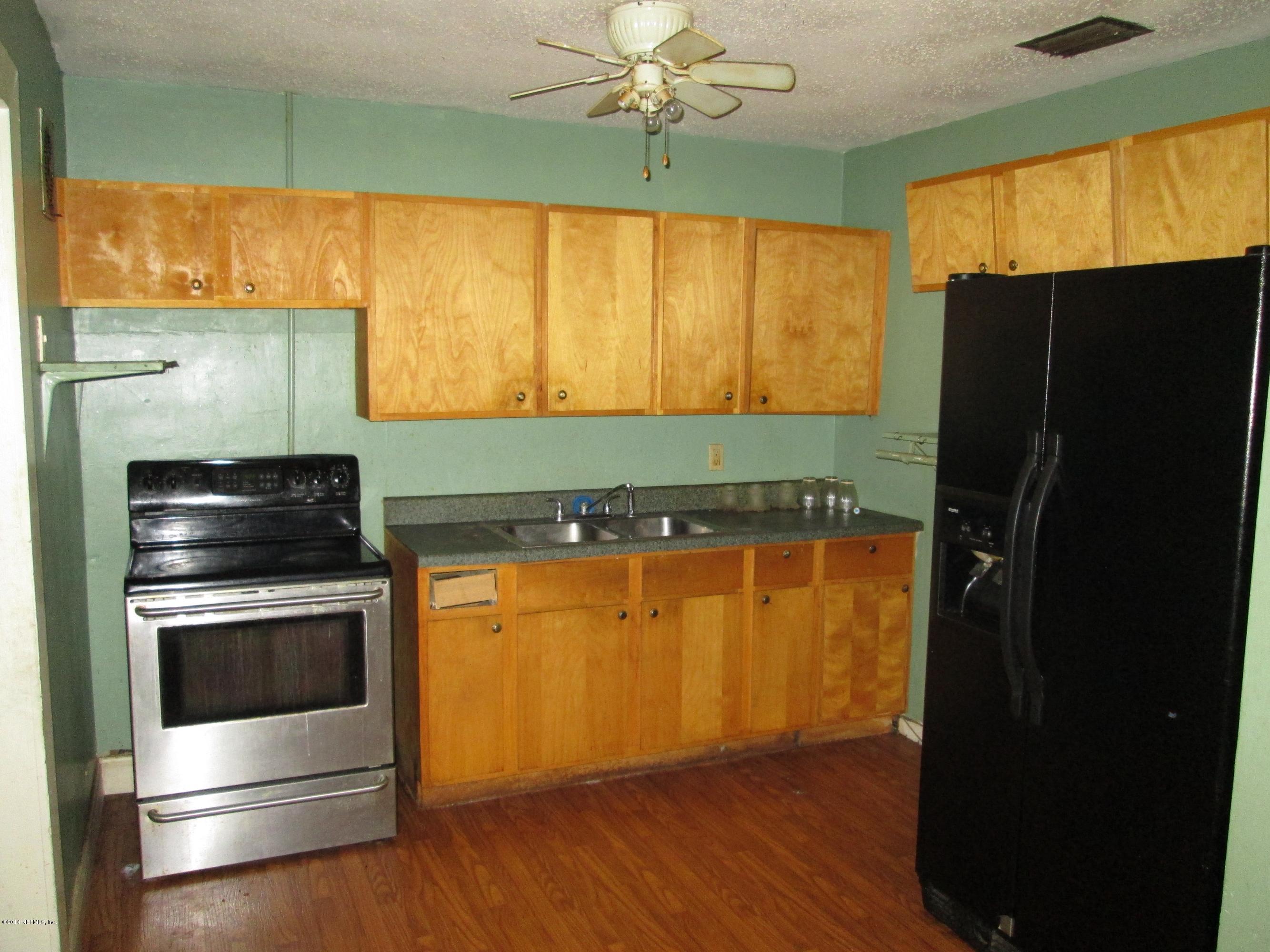 2235 Newberry Road Jacksonville, FL 32218 - Photo 5 of 12 a kitchen with stainless steel appliances a stove a refrigerator and a sink