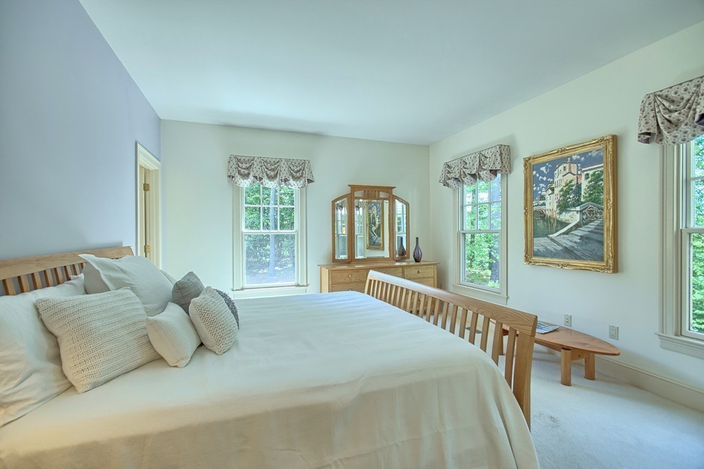 96 Forest Ridge Road, Unit 96 Concord, MA 01742 - Photo 12 of 24 a bedroom with a bed and a large window
