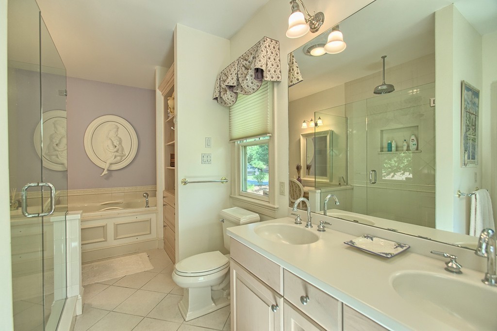 96 Forest Ridge Road, Unit 96 Concord, MA 01742 - Photo 13 of 24 a bathroom with a toilet a sink a mirror and a shower