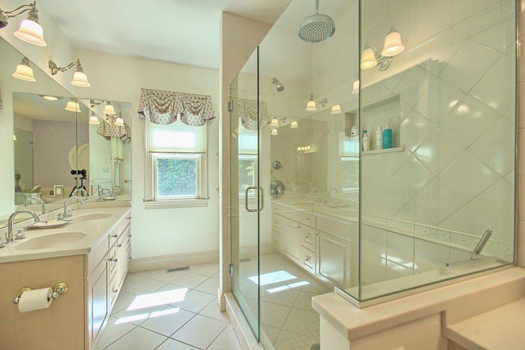 96 Forest Ridge Road, Unit 96 Concord, MA 01742 - Photo 14 of 24 a bathroom with a shower sink and mirror