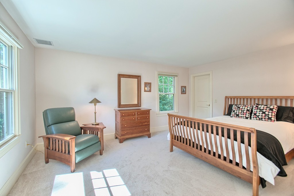 96 Forest Ridge Road, Unit 96 Concord, MA 01742 - Photo 15 of 24 a bedroom with furniture and a window