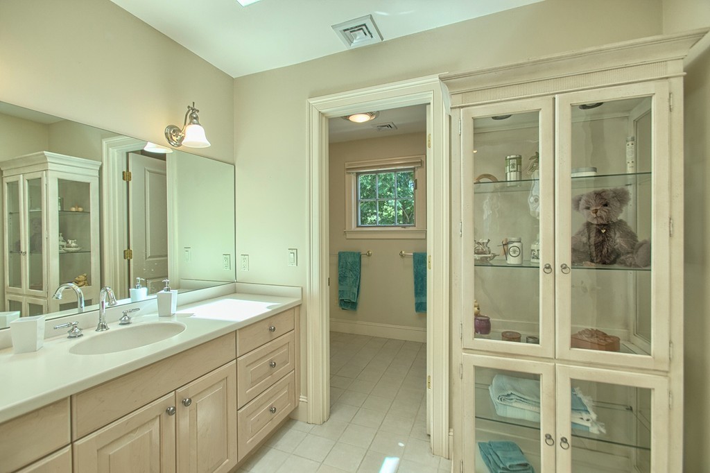 96 Forest Ridge Road, Unit 96 Concord, MA 01742 - Photo 16 of 24 a bathroom with a shower sink and mirror