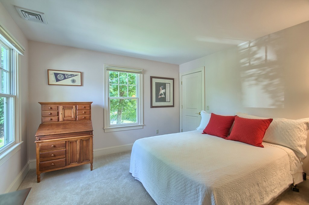 96 Forest Ridge Road, Unit 96 Concord, MA 01742 - Photo 17 of 24 a bedroom with a bed and a window