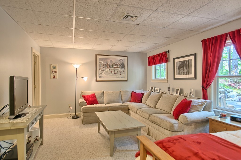96 Forest Ridge Road, Unit 96 Concord, MA 01742 - Photo 20 of 24 a living room with furniture a flat screen tv and a window