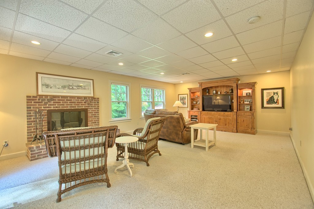 96 Forest Ridge Road, Unit 96 Concord, MA 01742 - Photo 21 of 24 a living room with furniture and a fireplace