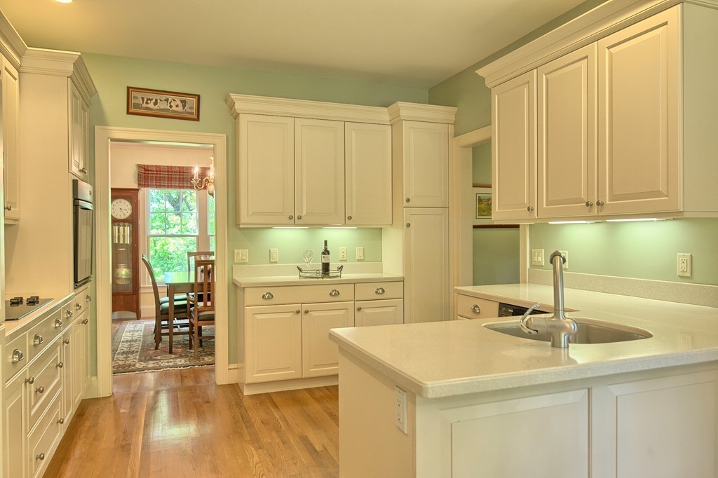 96 Forest Ridge Road, Unit 96 Concord, MA 01742 - Photo 6 of 24 a kitchen with a sink cabinets and wooden floor