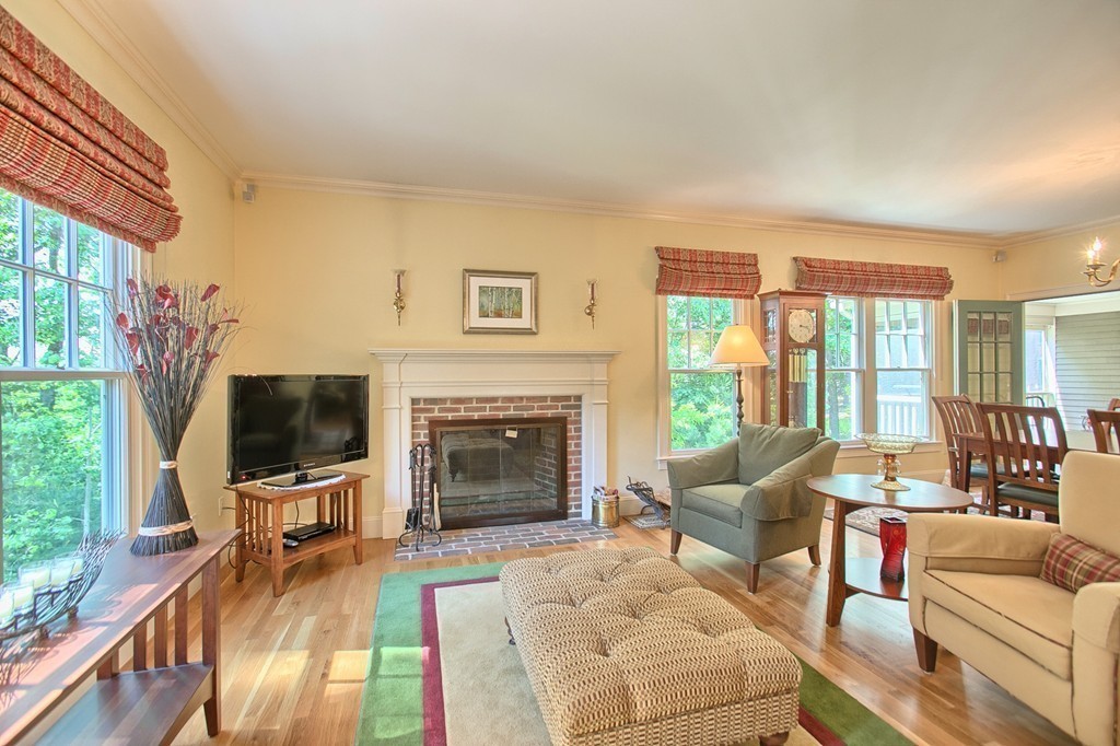96 Forest Ridge Road, Unit 96 Concord, MA 01742 - Photo 7 of 24 a living room with furniture a flat screen tv and a fireplace