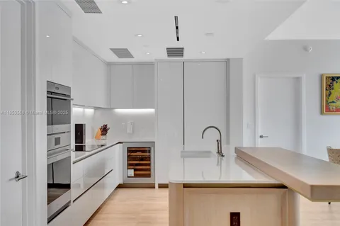 a kitchen with granite countertop a sink stainless steel appliances and cabinets