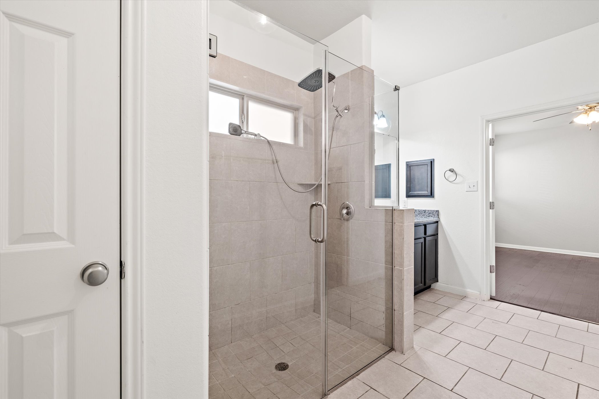 7337 Menchaca Road, Unit #22 Austin, TX 78745 - Photo 11 of 25 Bathroom with vanity, light tile patterned floors, and a shower stall