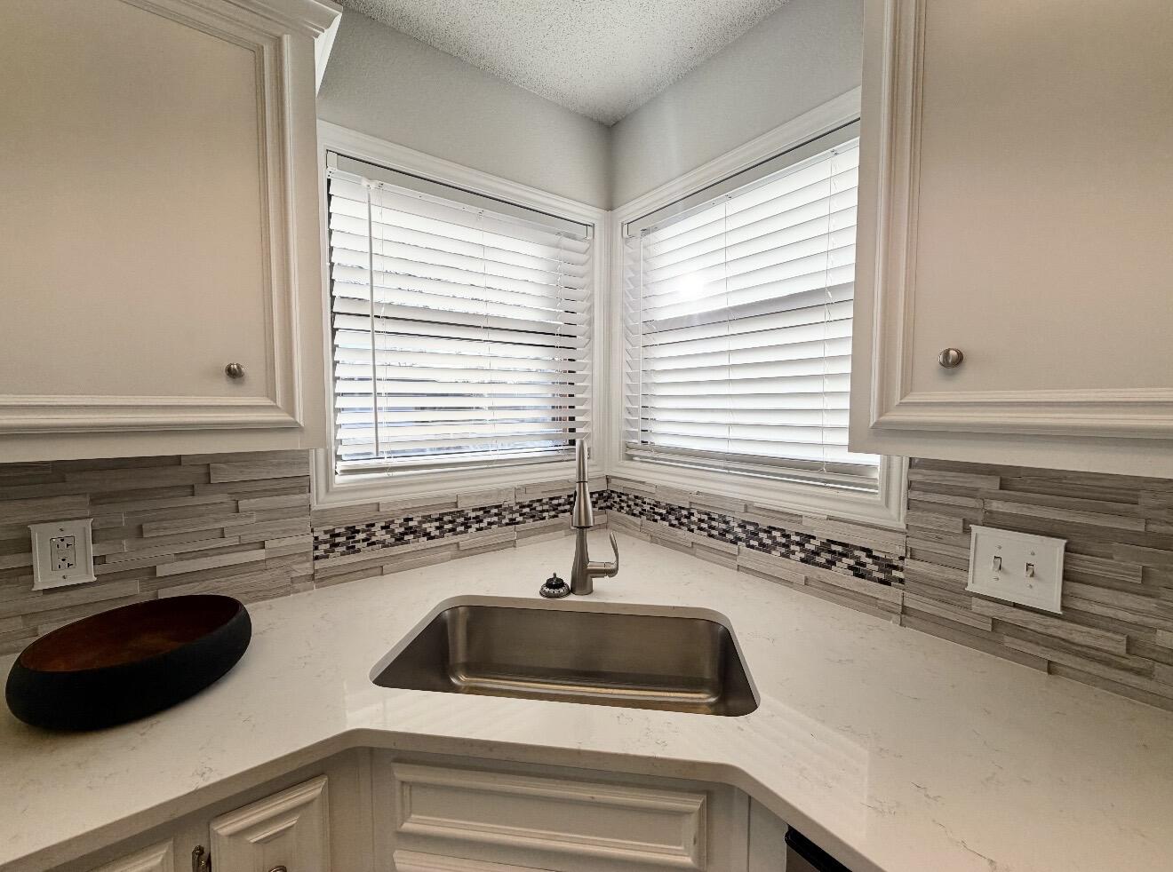 2318 94th Street Lubbock, TX 79423 - Photo 5 of 19 a kitchen with a sink and a window