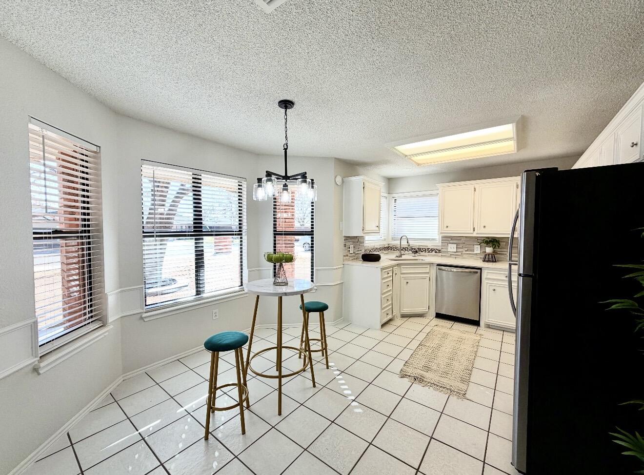 2318 94th Street Lubbock, TX 79423 - Photo 6 of 19 a kitchen with a sink cabinets and window