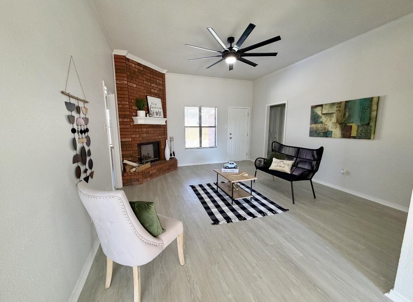 2318 94th Street Lubbock, TX 79423 - Photo 8 of 19 a living room with furniture a fireplace and a flat screen tv