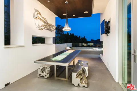 a room with pool table and a flat screen tv