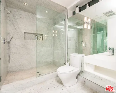 a bathroom with a shower a toilet and sink