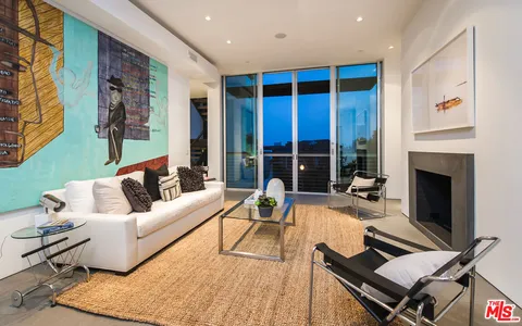 a living room with furniture rug and a fireplace