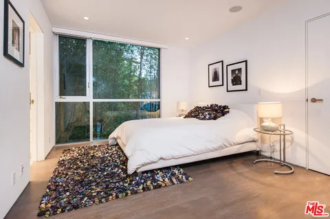 a bedroom with a large bed and a window