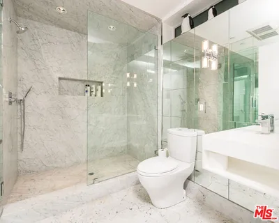 a bathroom with a shower a toilet and a sink