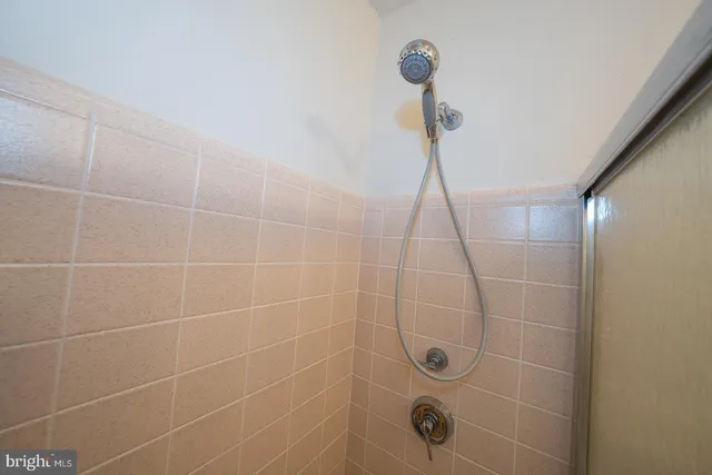 a bathroom with a granite countertop sink toilet and mirror