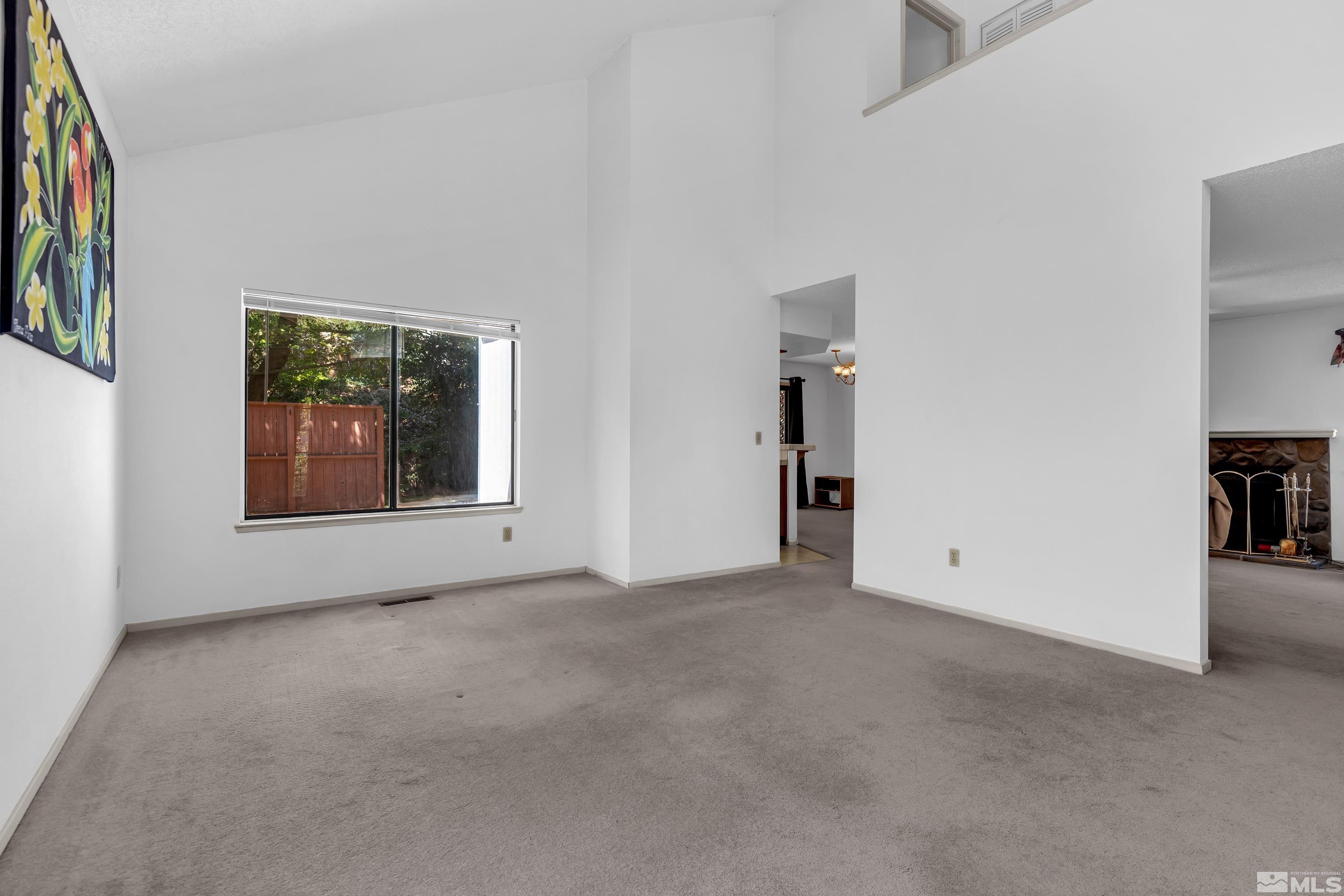 1791 Grand Point Way Reno, NV 89523 - Photo 3 of 24 an empty room with bookshelf