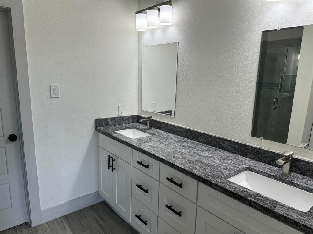 6043 Rivendell Drive Frisco, TX 75035 - Photo 14 of 21 a bathroom with a granite countertop sink and a mirror