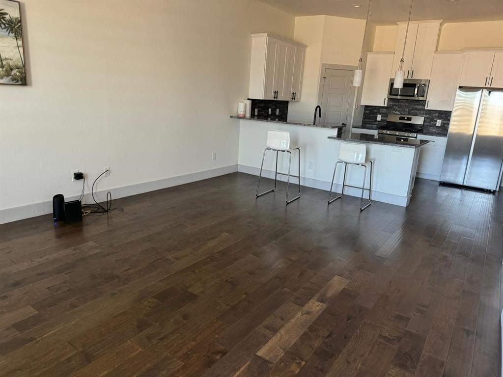 6043 Rivendell Drive Frisco, TX 75035 - Photo 2 of 21 a view of kitchen with wooden floor and electronic appliances