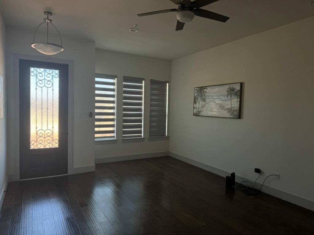 6043 Rivendell Drive Frisco, TX 75035 - Photo 7 of 21 a view of an empty room with a window and wooden floor