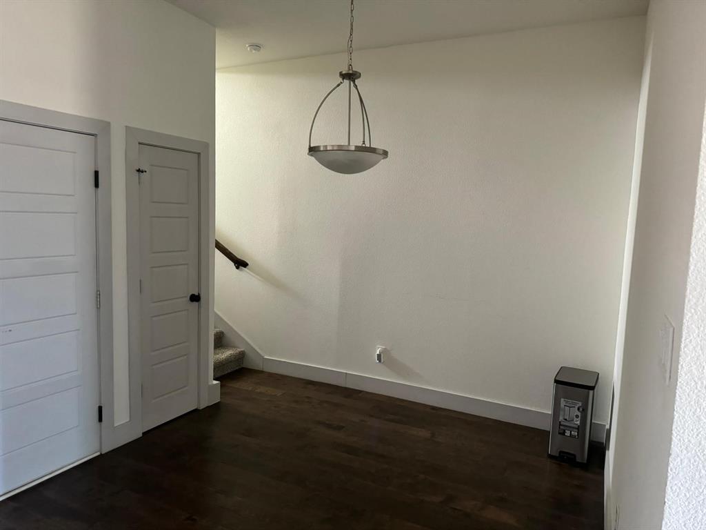 6043 Rivendell Drive Frisco, TX 75035 - Photo 10 of 21 a view of a room with wooden floor and white walls