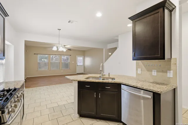 a kitchen with a sink and a refrigerator