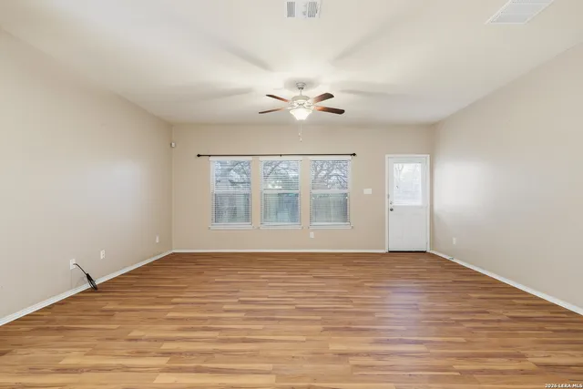 wooden floor in an empty room with a window