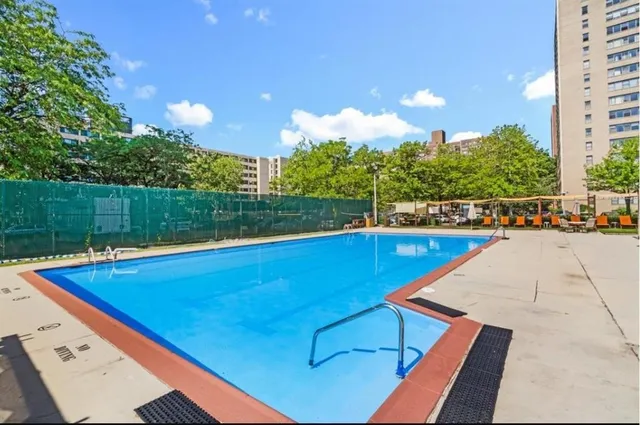 a view of a swimming pool and lounge chairs