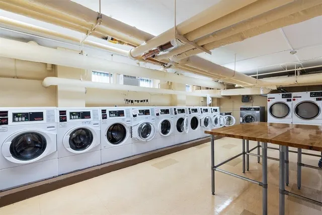 a utility room with lots of appliances and cabinets