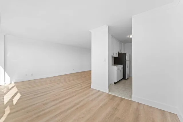 a view of a kitchen with a sink and a refrigerator
