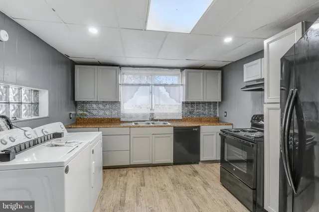 a kitchen with a sink stove and refrigerator
