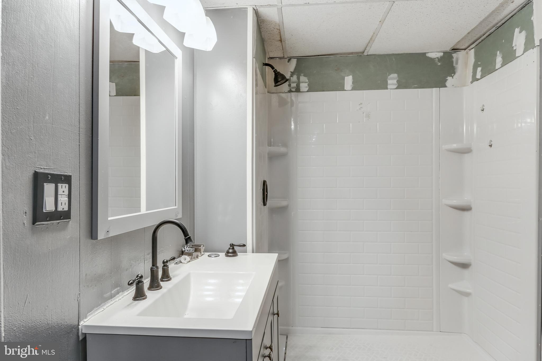 212 Beaver Road, Unit 1 Harrisburg, PA 17112 - Photo 7 of 11 a bathroom with a sink and mirror