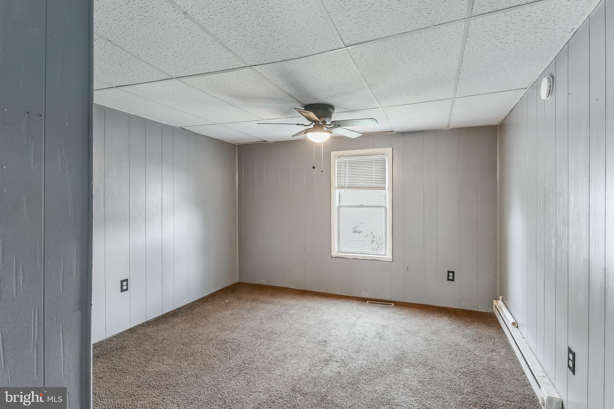 212 Beaver Road, Unit 1 Harrisburg, PA 17112 - Photo 8 of 11 an empty room with windows and ceiling fan