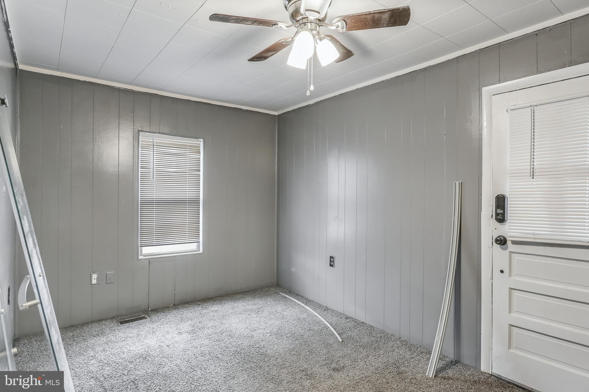 212 Beaver Road, Unit 1 Harrisburg, PA 17112 - Photo 9 of 11 an empty room with windows and fan